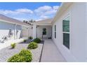 Side yard with gravel landscaping and walkway at 5238 Dalessandro Rd, The Villages, FL 32163