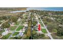 Aerial view showing the home's location in a residential neighborhood near the water at 12425 Pine Island Dr, Leesburg, FL 34788