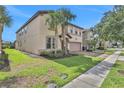 Two-story house with palm trees and brick driveway at 1603 Lima Ave, Kissimmee, FL 34747