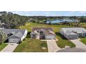 Aerial view of three homes near a lake and golf course at 25114 Meriweather Rd, Leesburg, FL 34748