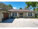 House exterior featuring a double door entry and attached garage at 33413 Fairway Rd, Leesburg, FL 34788