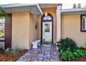 Inviting front entry with tiled walkway and bench at 33516 Overton Dr, Leesburg, FL 34788