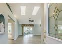 Spacious living room with vaulted ceilings and skylights at 33516 Overton Dr, Leesburg, FL 34788