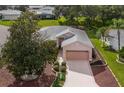 Aerial view of the house, showing landscaping and driveway at 4803 Sawgrass Lake Cir, Leesburg, FL 34748