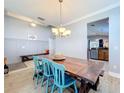 Farmhouse style dining room with a large wooden table and teal chairs at 4850 Royce Dr, Mount Dora, FL 32757