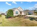 One story house with a well-manicured lawn and landscaping at 1429 Bluebeard Ct, The Villages, FL 32163