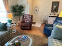 Living room showcasing a comfy recliner and wood flooring at 5006 El Destino Dr, Leesburg, FL 34748