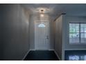 Bright entryway with a white door and dark flooring at 769 Cr 533, Sumterville, FL 33585