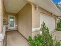 Front entrance with a white door, decorative glass, and walkway at 11036 Cr 229, Oxford, FL 34484