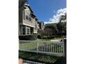 Two story house with gray siding, a white picket fence and a neat lawn at 12144 Bruceton Way # 101, Orlando, FL 32828