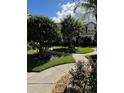 Landscaped walkway and yard with lush green grass and plants at 12144 Bruceton Way # 101, Orlando, FL 32828