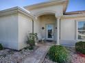 Inviting front porch with a charming bench and stone walkway at 13544 Se 87Th Cir, Summerfield, FL 34491