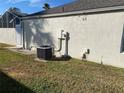 Rear exterior showing AC unit and other utilities at 1964 Banning Beach Rd, Tavares, FL 32778