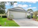 One-story house with a two-car garage and well-maintained lawn at 4130 Capland, Clermont, FL 34711