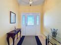 Bright entryway with a wood console table and a glass-top table at 4634 Summerbridge Cir, Leesburg, FL 34748