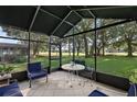 Relaxing screened porch overlooking lush backyard at 5533 Grove Mnr, Lady Lake, FL 32159
