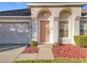 Front view of the house entrance with a beige door and arched entryway at 31748 Parkdale Dr, Leesburg, FL 34748