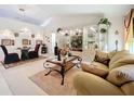Living room with beige sofa, glass coffee table, and decorative accents at 31748 Parkdale Dr, Leesburg, FL 34748