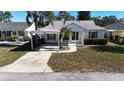 House exterior with carport and landscaped yard at 3211 Lupine Way, Lake Wales, FL 33898