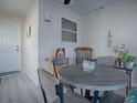 Bright dining area with round table and four chairs, situated near a sunroom at 409 Rose Croft Ter, The Villages, FL 32162