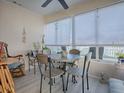 Bright dining area with round table and four chairs, situated near a sunroom at 409 Rose Croft Ter, The Villages, FL 32162