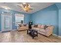 Light-filled living room with neutral furniture and lake views at 561 Juniper Springs Dr, Groveland, FL 34736