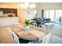 Open concept dining area with seating for six and view to the living room at 6309 Danielson Loop, The Villages, FL 32163