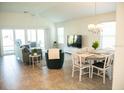 Open living and dining area with tile floors and sliding glass doors at 6309 Danielson Loop, The Villages, FL 32163