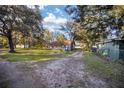 Landscaped backyard with grassy area and mature trees at 10285 Ne 218Th Lane Rd, Fort Mc Coy, FL 32134