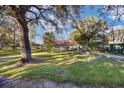 Large grassy side yard with mature trees and a shed at 10285 Ne 218Th Lane Rd, Fort Mc Coy, FL 32134