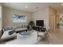 Spacious living room featuring a sectional sofa, large TV, and neutral decor at 13245 Peaceful Melody Dr, Winter Garden, FL 34787