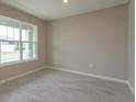 Small home office space with large window and neutral color scheme at 13245 Peaceful Melody Dr, Winter Garden, FL 34787