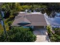 Lakefront home with driveway and garage at 13724 Country Club Dr, Tavares, FL 32778