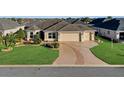 Attractive one-story home with a two-car garage and nicely landscaped yard at 1494 Walnut Way, The Villages, FL 32163