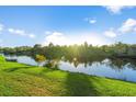 Scenic view of a lake with lush green grass at 1725 Strathmore Cir, Mount Dora, FL 32757