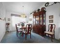 Charming dining area with a wooden table and matching chairs, plus a china cabinet at 21502 King Henry Ave, Leesburg, FL 34748