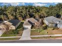 Aerial view of a residential neighborhood with houses and green areas at 2354 Valhalla Dr, Tavares, FL 32778