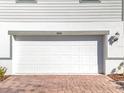 White garage door with paver driveway at 30224 Armenia Rd, Leesburg, FL 34748