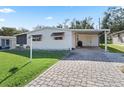Front view of a single-wide manufactured home with paved driveway at 712 Tarrson Blvd, The Villages, FL 32159