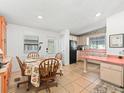 Eat-in kitchen with light wood cabinets and a dinette set at 712 Tarrson Blvd, The Villages, FL 32159