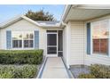 Front entrance with a screened porch and walkway at 7808 Se 168Th Lone Oak Loop, The Villages, FL 32162