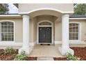 Elegant entryway with double doors and columns at 14701 Timucua Pl, Clermont, FL 34711