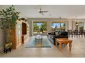 Spacious living room with tiled floors, a leather couch, and access to the pool area at 4236 Fawn Meadows Cir, Clermont, FL 34711