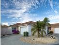 Front view of a light brown single-Gathering home with palm trees at 872 Oviedo Rd, The Villages, FL 32159