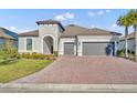 Two-story home with a two-car garage and landscaped yard at 955 Ladera Ranch Rd, Kissimmee, FL 34759