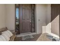 Front entry with brown door, brick walkway, and bench at 1150 Blarney St, Minneola, FL 34715