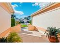 Pathway leads to the front door, bordered by lush greenery at 1589 Arial Pl, The Villages, FL 32162