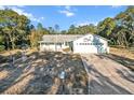 Single-story home with a large yard and driveway at 17469 Sw 35Th Avenue Rd, Ocala, FL 34473