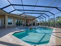 Inviting screened pool with fountain and spacious patio at 4033 King Pl, The Villages, FL 32163