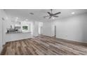 Open concept living area with wood-look flooring and neutral walls at 40630 E Eighth Ave, Umatilla, FL 32784